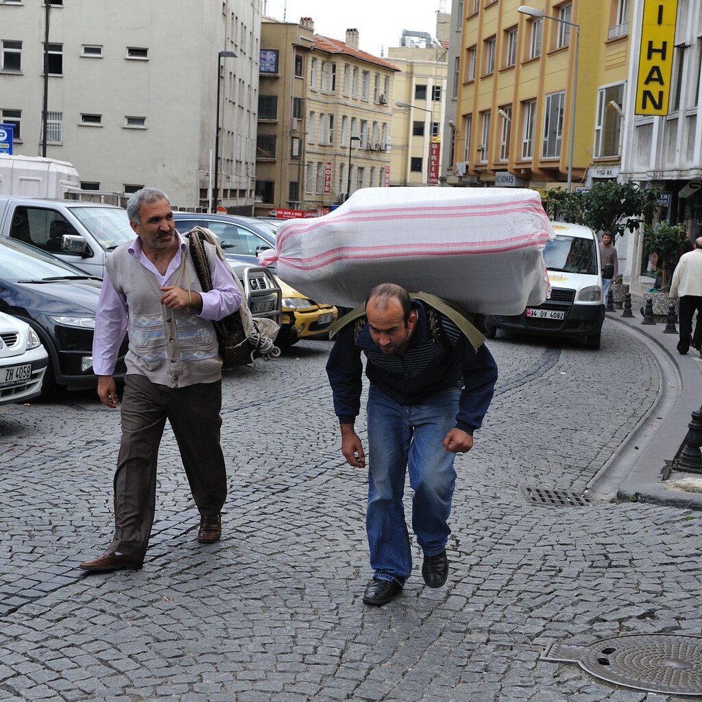 Photo of a man bearing a burden