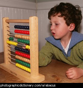 Photo of a boy using an abacus.