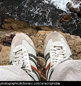 Photo of someone standing on a cliff edge