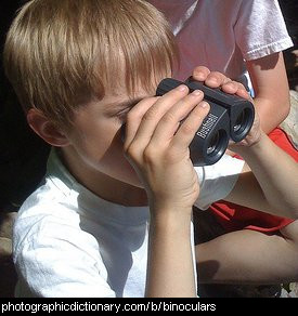 Photo of a child looking through binoculars