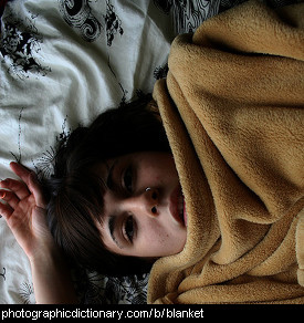 Photo of a girl under a blanket