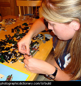 Photo of someone building something out of lego