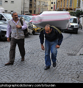 Photo of a man bearing a burden