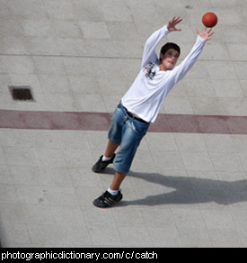 Photo of a boy catching a ball