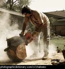Photo of a man using a chainsaw