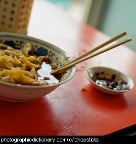 Photo of chopsticks in a bowl.