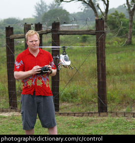 Photo of a man flying a remote control helicopter