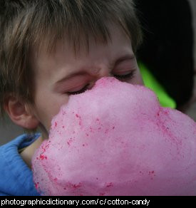 Photo of a boy eating cotton candy