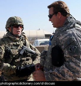 Photo of two men in the army having a discussion