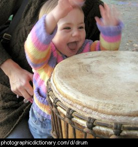 Photo of a child playing the drums.