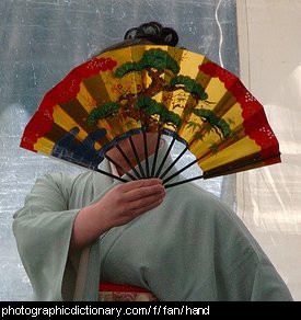 Photo of a woman holding a fan