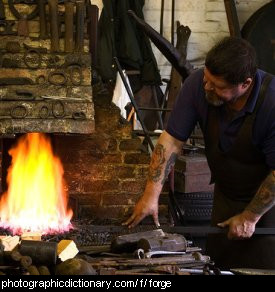 Photo of a blacksmith using a forge