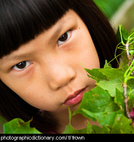 Photo of a girl frowning.