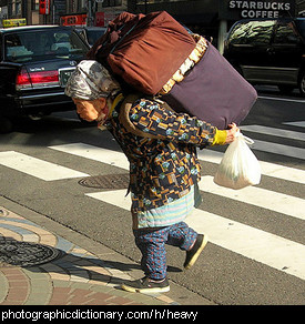 Photo of a woman carrying a heavy load