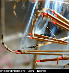 Photo of incense sticks burning.