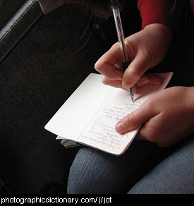 Photo of someone jotting down notes