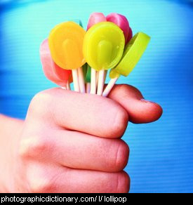 Photo of a child holding lollypops