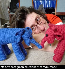 Photo of a woman who made some knitted elephants