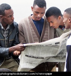 Photo of some men reading a newspaper