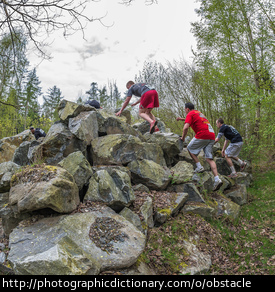 Photo of men going through an obstacle course