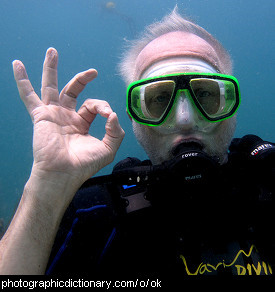 Photo of a man making an ok hand signal