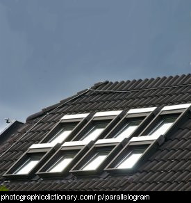 Photo of windows on a roof that look like parallelograms.