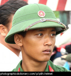 Photo of a young man wearing a pith helmet