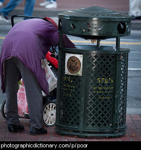 Photo of a woman looking through a trash can