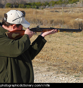 Photo of a man aiming a rifle.