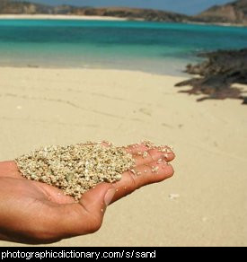Photo of a hand holding sand