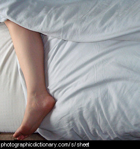 Photo of white sheets on a bed.