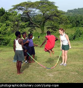 Photo of some African children playing jump rope