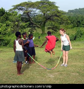 Photo of some African children playing jump rope
