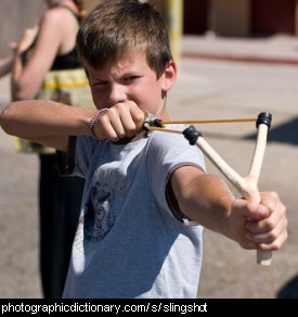 Photo of a boy using a slingshot