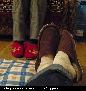 Photo of feet wearing slippers.