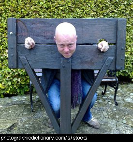 Photo of a man in stocks