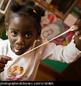 Photo of a girl stretching chewing gum