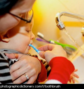 Photo of a child using a toothbrush