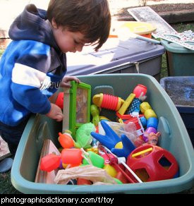 Photo of a child with a box of toys