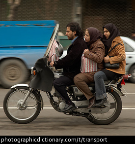 Photo of three people on a motorbike
