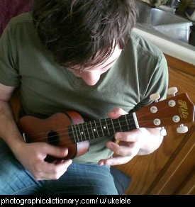Photo of a man playing a ukelele