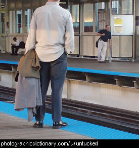 Photo of a man with his shirt untucked