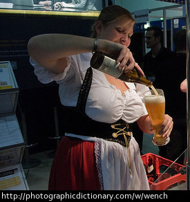 Woman dressed as a wench, serving beer.