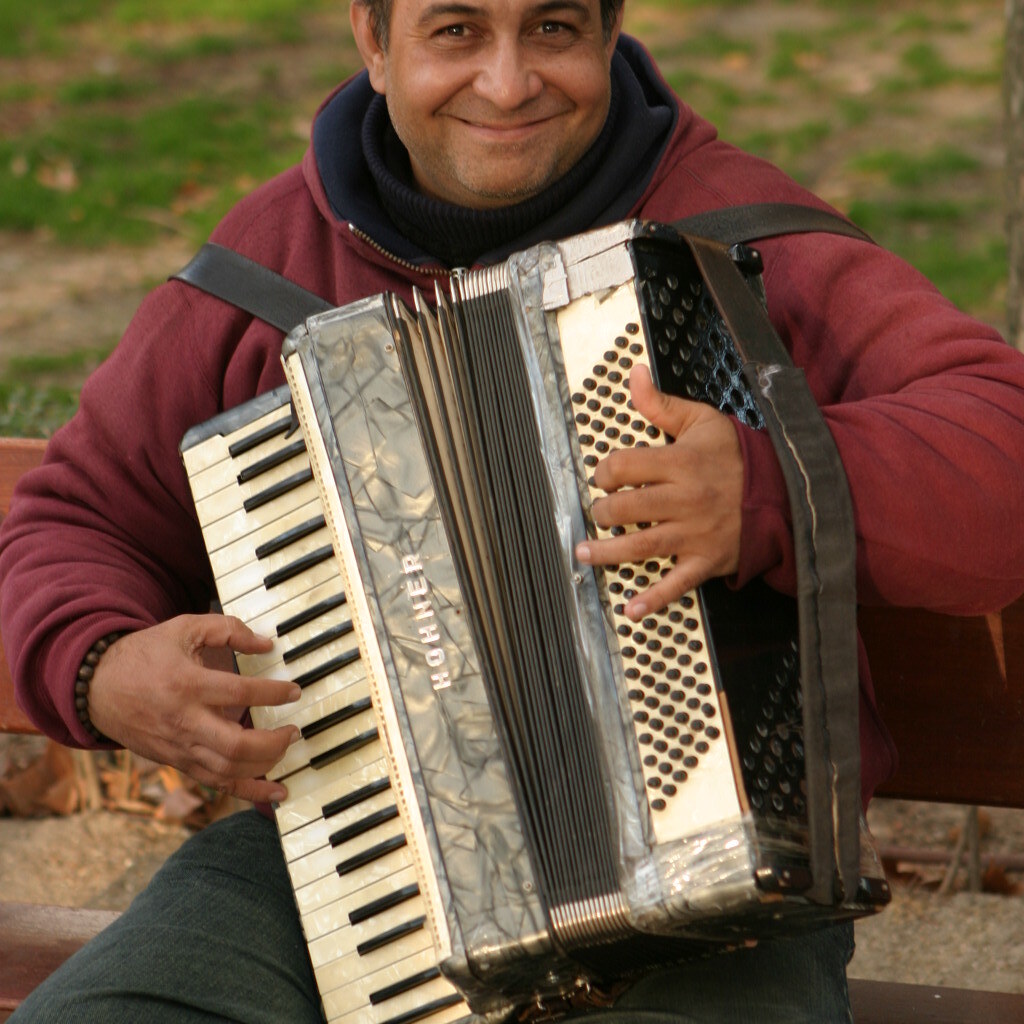 Photo of a man playing an accordian.