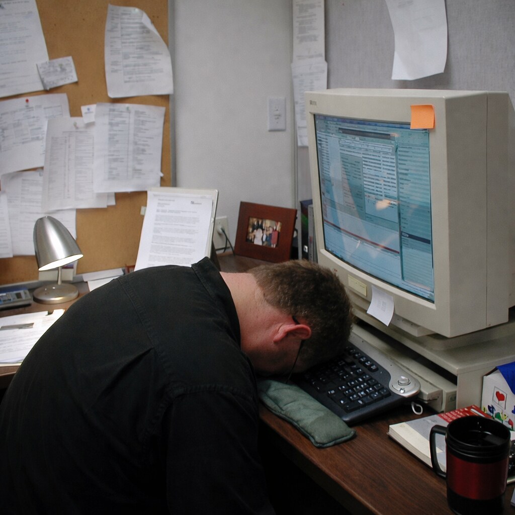 Altered image of a man passed out at his computer