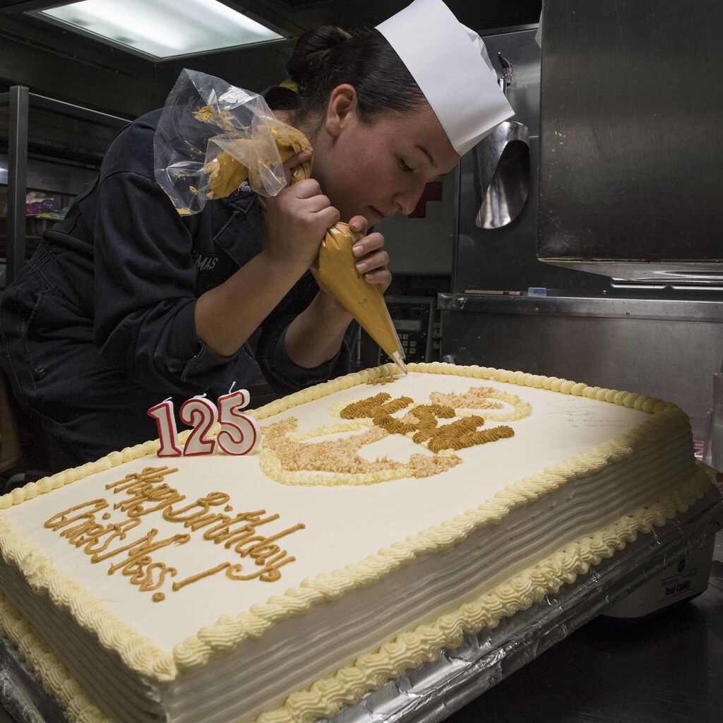 Photo of someone decorating a cake