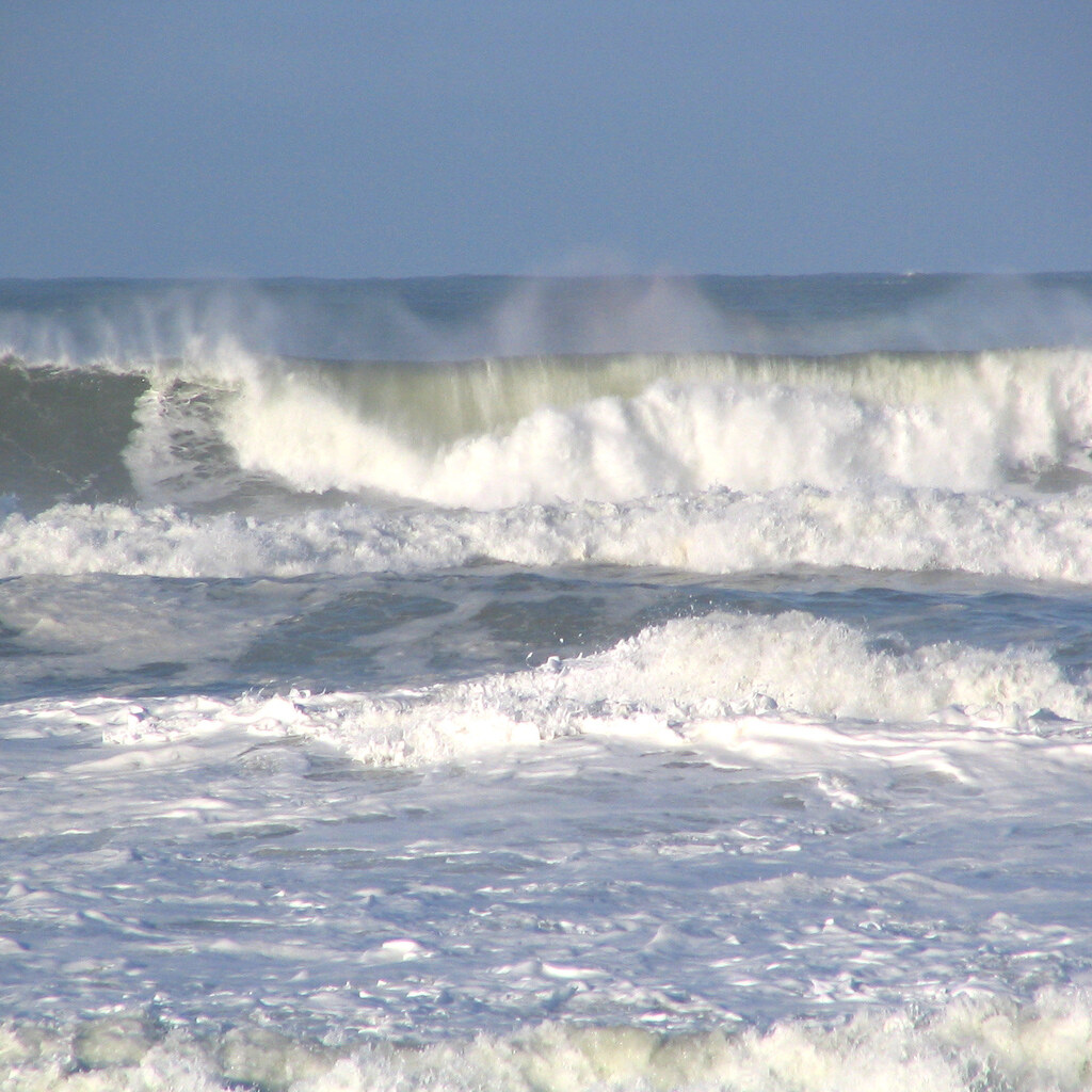 Photo of waves breaking on the shore.